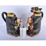 A PAIR OF LATE 18TH/19TH CENTURY PRATTWARE BEAR BAITING JUGS each modelled holding a scowling beast,