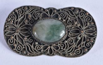 A Filigree Brooch set with a Jade Cabochon. 4.8 cm x 2.6 cm, weight 11.65g