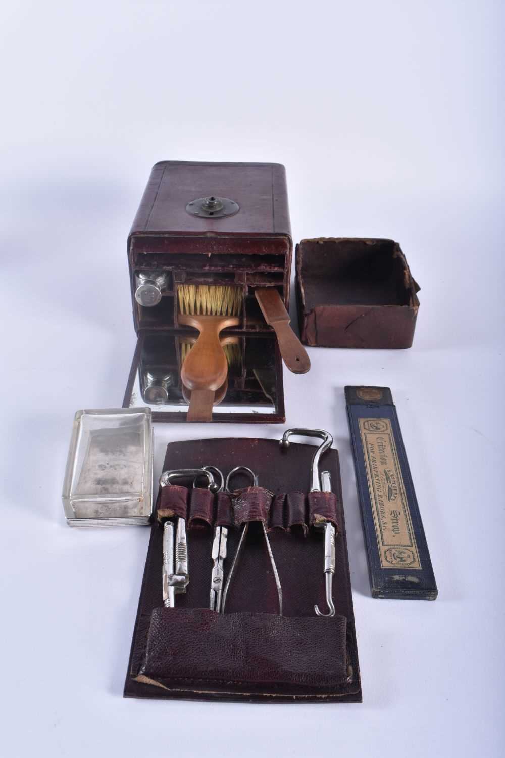 A RARE LATE VICTORIAN LEATHER CASED TRAVELLING BARBERS KIT with fitted interior. Box 21 cm x 10 cm. - Image 2 of 2