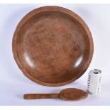 A CARVED DAIRY WOOD TREEN BUTTER BOWL AND SPOON. Bowl 40 cm diameter. (2)