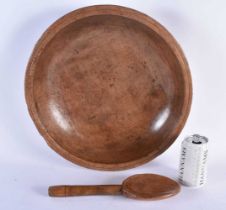 A CARVED DAIRY WOOD TREEN BUTTER BOWL AND SPOON. Bowl 40 cm diameter. (2)