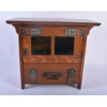AN ART NOUVEAU OAK SMOKERS CABINET with stylised brass strapwork. 30cm x 28 cm.