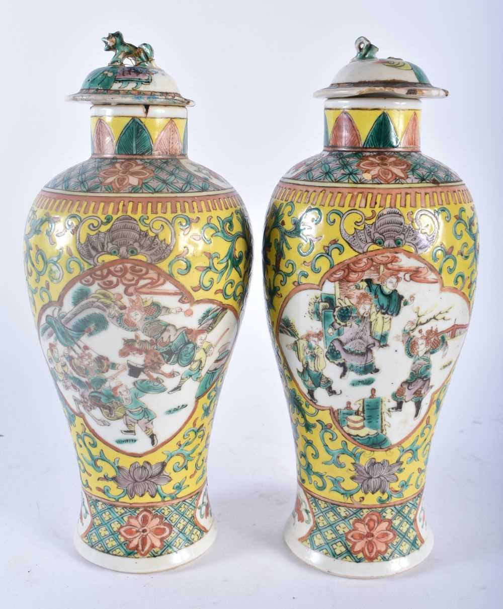 A PAIR OF 19TH CENTURY CHINESE FAMILLE JAUNE PORCELAIN VASES AND COVERS Qing, painted with figures