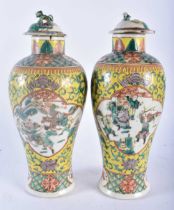 A PAIR OF 19TH CENTURY CHINESE FAMILLE JAUNE PORCELAIN VASES AND COVERS Qing, painted with figures