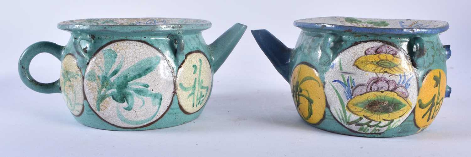 A PAIR OF 19TH CENTURY CHINESE ENAMELLED YIXING POTTERY TEAPOTS painted with flowers. 15 cm wide.