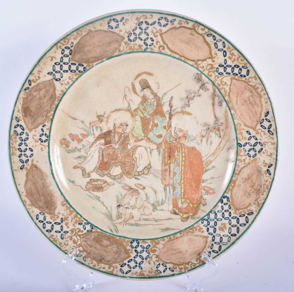 A 19TH CENTURY JAPANESE MEIJI PERIOD SATSUMA PLATE painted with immortals. 24 cm diameter.