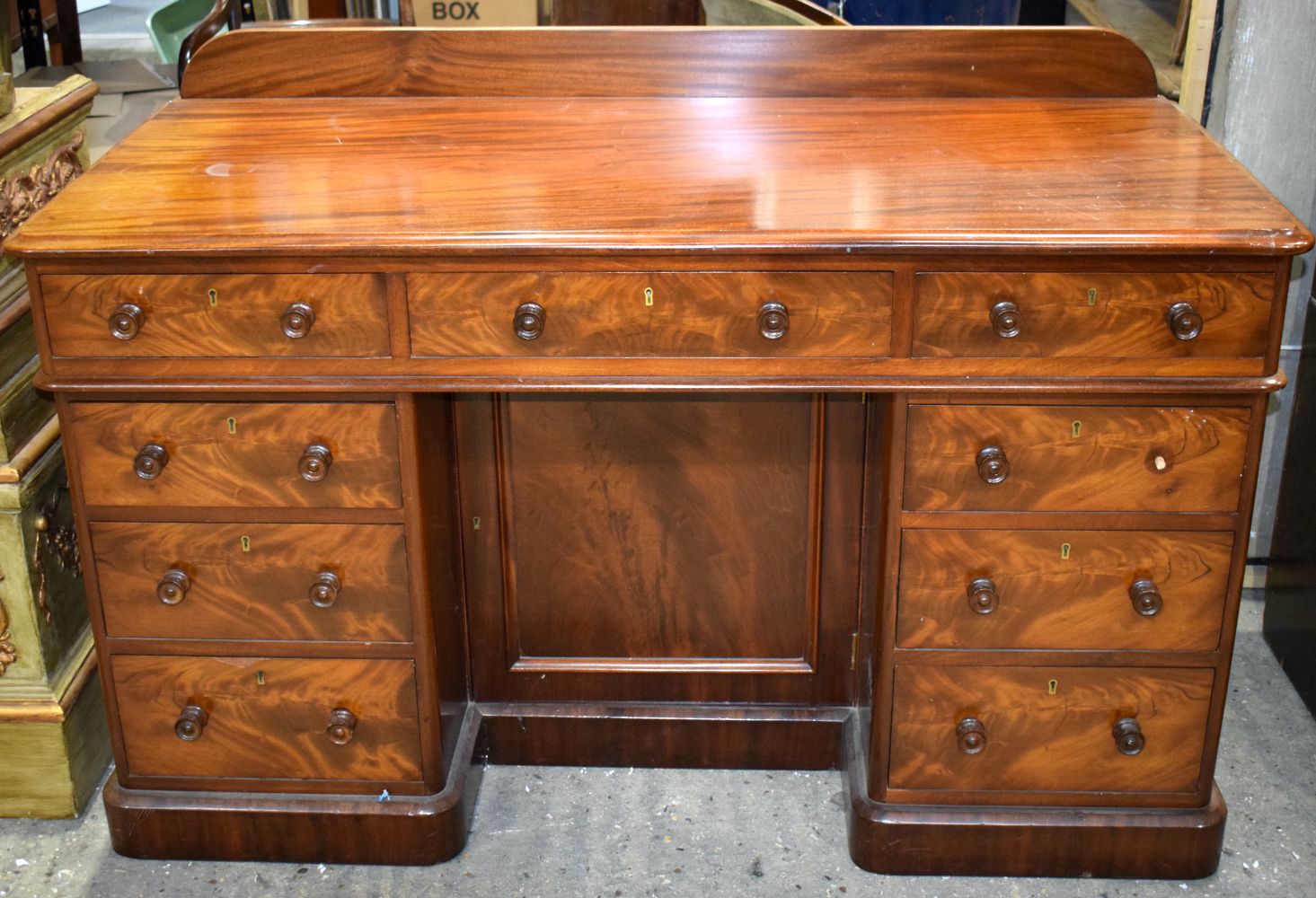 A Victorian flame mahogany 9 draw pedestal desk 90 x 136 x 61 cm.