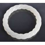 A CHINESE CARVED WHITE JADE TWIST BANGLE 20th Century. 43 grams. 6.5 cm diameter.