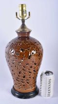 A CHINESE BROWN GLAZED RETICULATED LAMP decorated with foliage. 42 cm high.