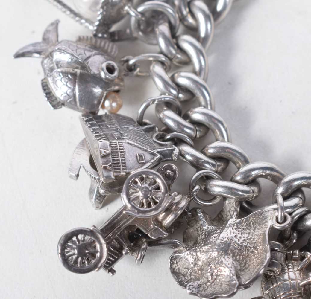 A Vintage Silver Charm Bracelet with 23 Charms. Bracelet Hallmarked Birmingham 1966. 4.2 cm internal - Image 3 of 5