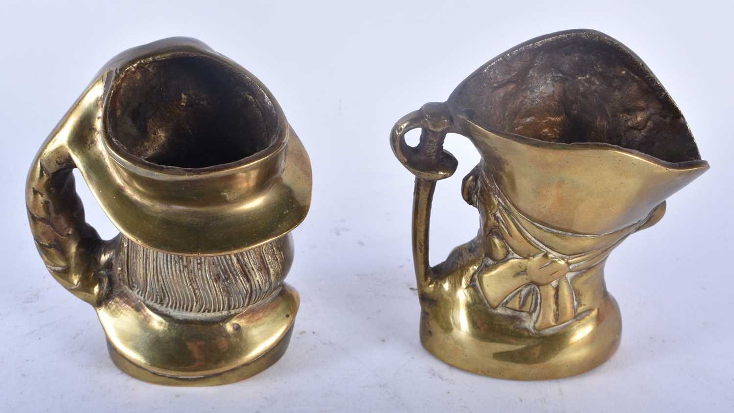 A RARE PAIR OF 19TH CENTURY ENGLISH BRONZE CHARACTER JUGS modelled as male and pirate. 11cm x 9 cm. - Image 4 of 5