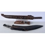 A large Indian Kukri with leather sheath together with a large South American knife with a carved