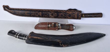 A large Indian Kukri with leather sheath together with a large South American knife with a carved