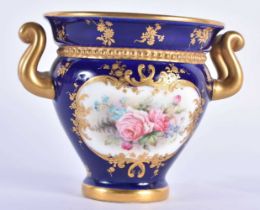Royal Worcester two handled vase painted with roses in panel on a cobalt blue ground date mark