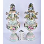 A LARGE PAIR OF 19TH CENTURY GERMAN PORCELAIN TWIN HANDLED VASES AND COVERS modelled as putti