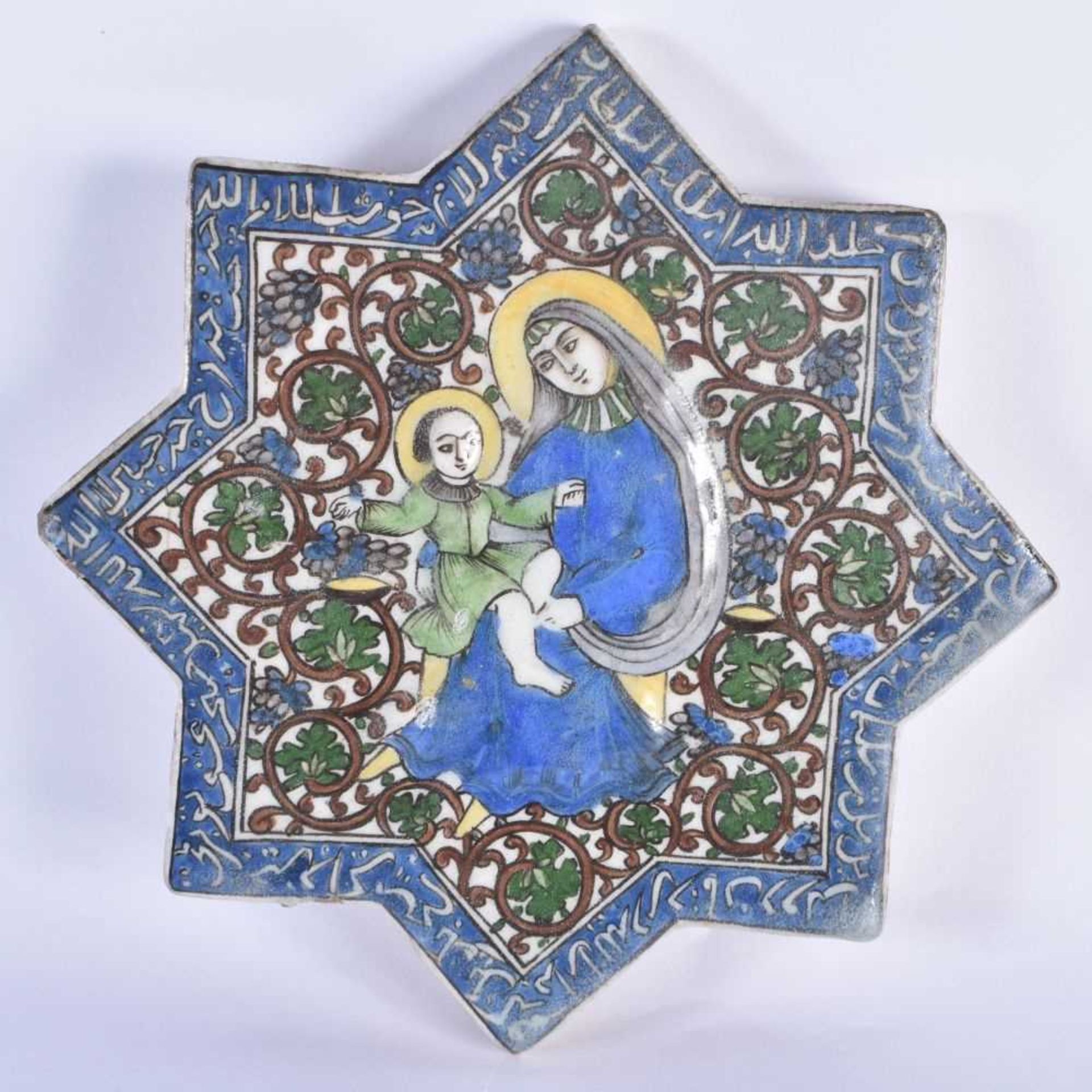 A 19TH CENTURY PERSIAN QAJAR POTTERY TILE painted with a female and child amongst calligraphy. 20 cm