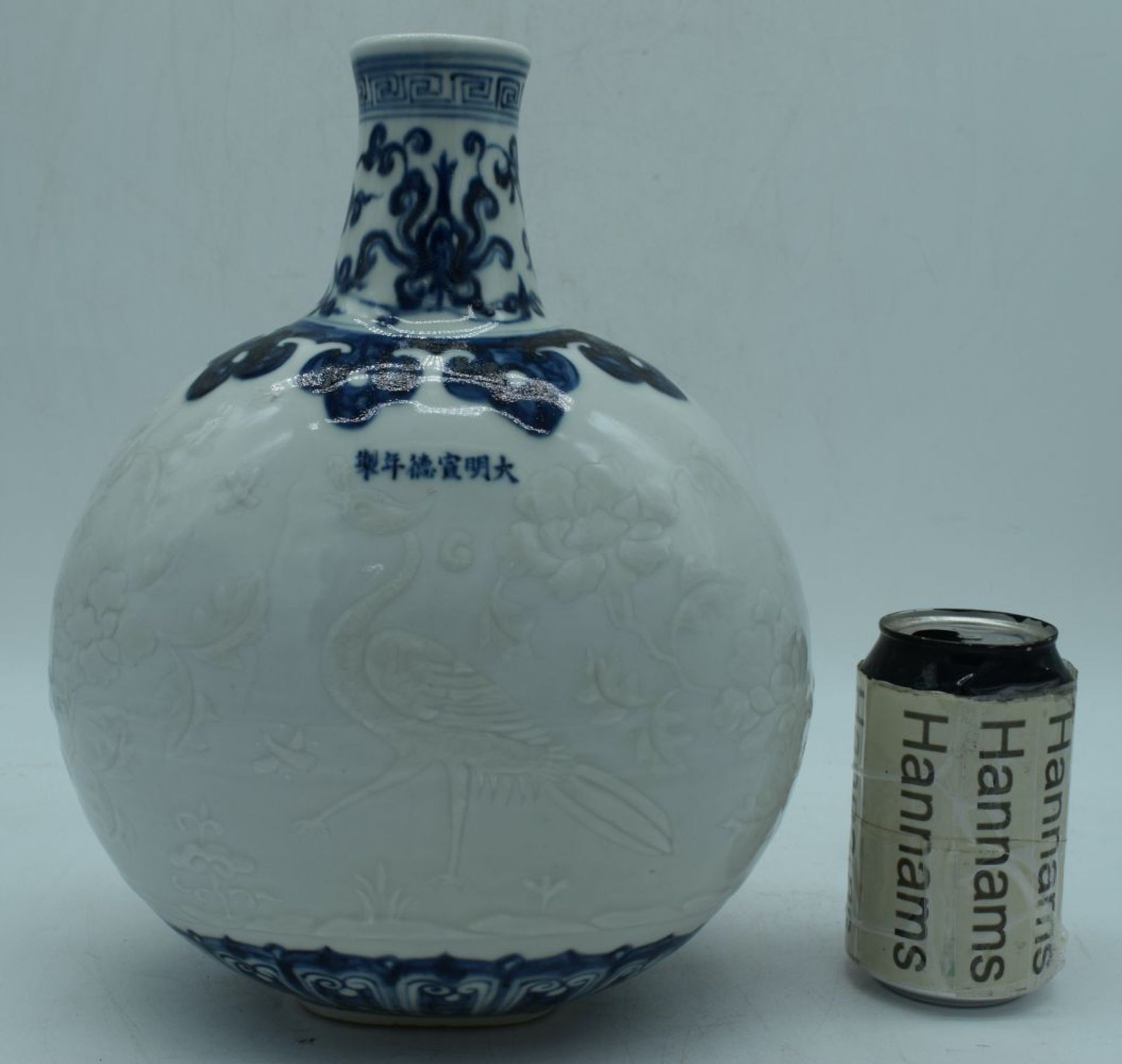 A Chinese porcelain Moon flask decorated in relief with Phoenix and foliage 29 cm.