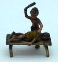 A VERY RARE ANTIQUE COLD PAINTED BRONZE TRIBAL BEATING FIGURE. 22.3 grams. 3.5 cm x 3.5 cm.