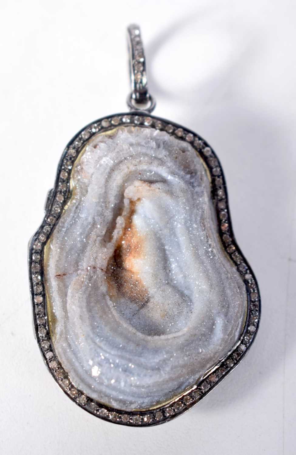 A Stone Pendant with Diamond Surround. 6.8 cm x 3.7cm, weight 24g