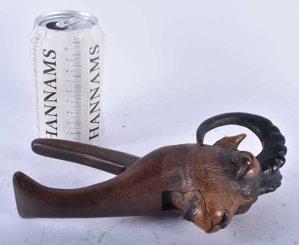 A PAIR OF 19TH CENTURY BAVARIAN BLACK FOREST CARVED WOOD IBEX NUT CRACKERS. 19 cm high.