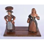 A Naive Folf Art Book Slide the ends carved as two 17th Century Peasant Ladies. 30cm x 23cm x 14cm