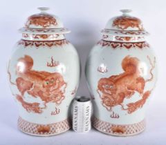 A LARGE PAIR OF CHINESE QING DYNASTY IRON RED PAINTED GINGER JARS AND COVERS painted with buddhistic