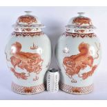 A LARGE PAIR OF CHINESE QING DYNASTY IRON RED PAINTED GINGER JARS AND COVERS painted with buddhistic