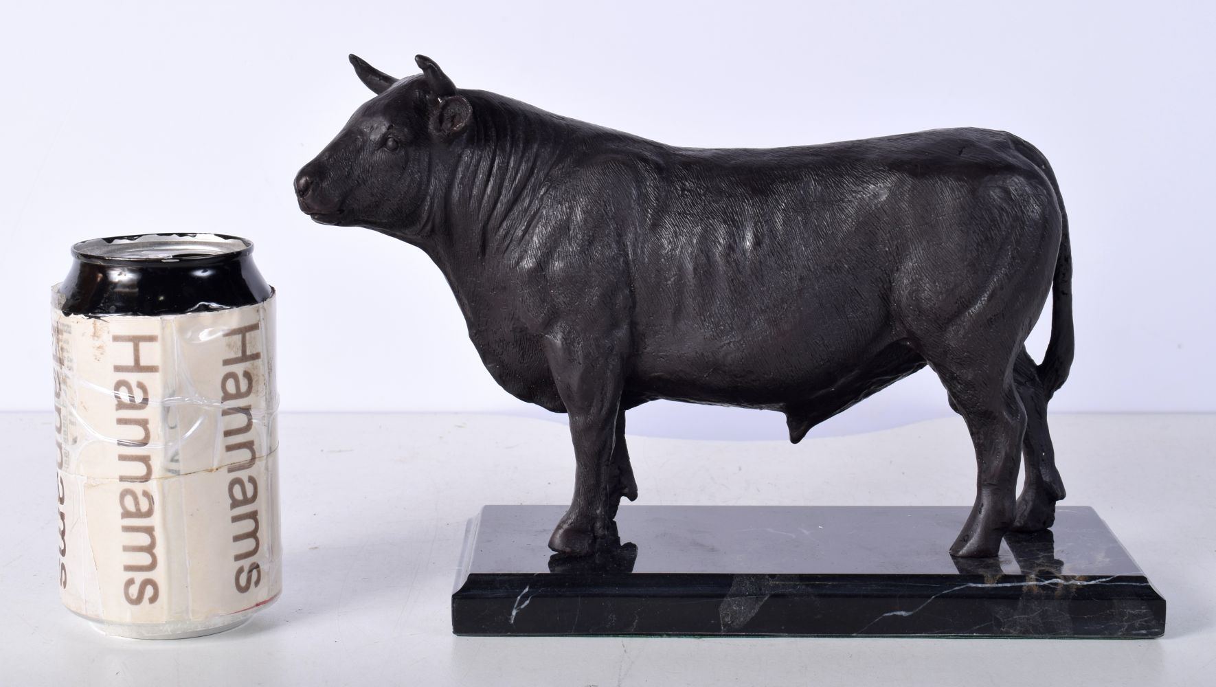 A Bronze bull mounted on a marble plinth 17 x 21 cm