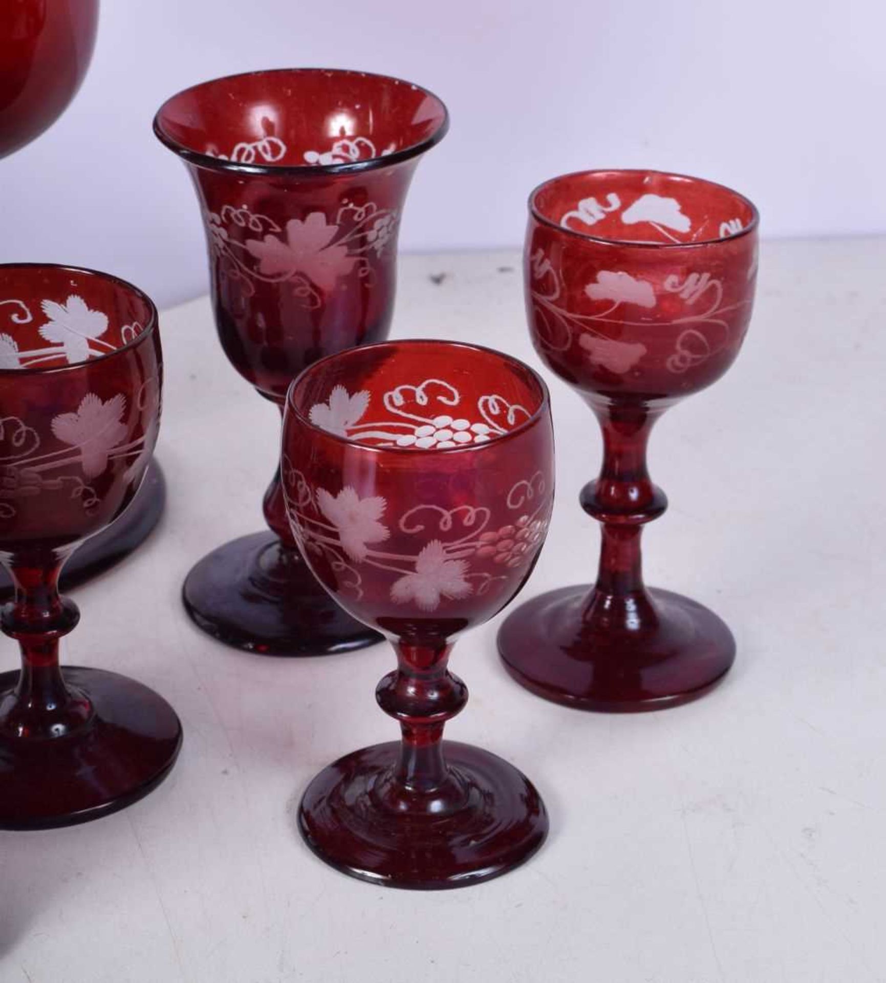 A collection of 1950's Bohemian Ruby wine glasses engraved with a Floral pattern together with a - Image 5 of 8