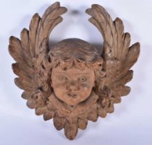 A FINE 18TH CENTURY NORTHERN EUROPEAN CARVED WOOD HEAD OF A PUTTI flanked by foliage. 22 cm x 24