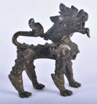 AN 18TH CENTURY CAMBODIAN BRONZE FIGURE OF A ROAMING BEAST modelled scowling. 10 cm x 10 cm.