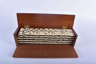 A CASED SET OF LATE 19TH/20TH CENTURY CARVED BONE DOMINOS possibly Prisoner of war, contained within