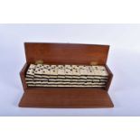 A CASED SET OF LATE 19TH/20TH CENTURY CARVED BONE DOMINOS possibly Prisoner of war, contained within