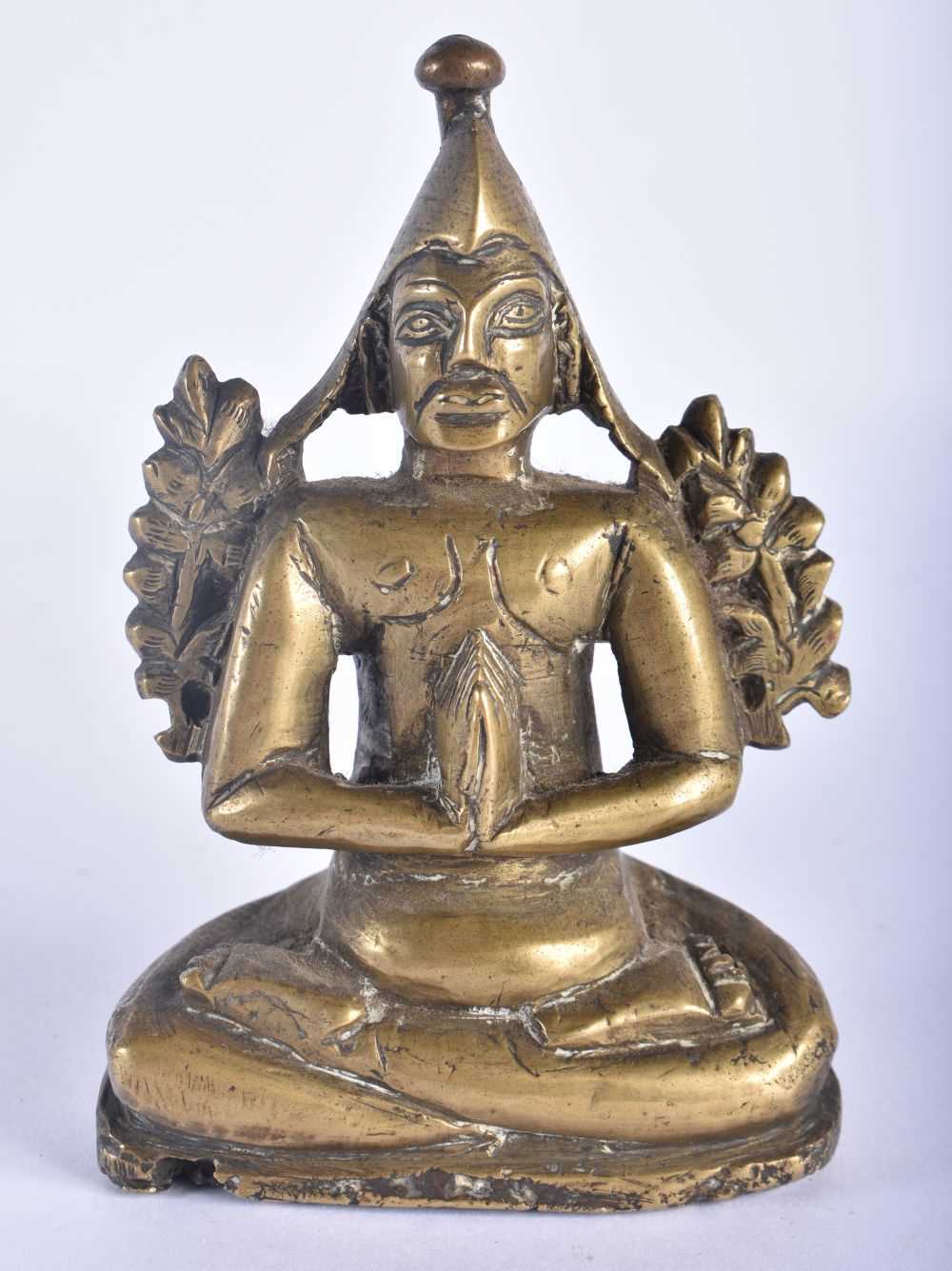 A 17TH/18TH CENTURY INDIAN BRONZE FIGURE OF A SEATED MALE DEITY modelled with hands clasped. 12 cm x