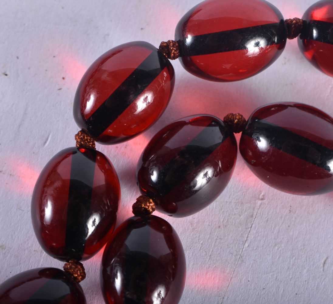 A CHERRY AMBER TYPE RED BEAD NECKLACE. 85 grams. 82 cm long. - Image 2 of 3