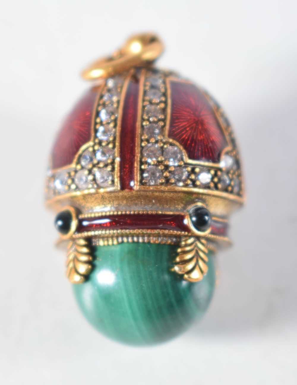 A Continental Silver Gilt, Enamel and Malachite Egg Pendant. Stamped 84, 2.6 cm x 1.7cm, weight 10.