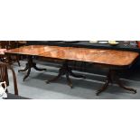 A FINE LARGE REGENCY CARVED MAHOGANY DINING TABLE with bronze capped supports, and two drop in