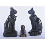 AN ANTIQUE EGYPTIAN REVIVAL BRONZE SPHINX together with a pair of cats. Largest 16 cm high. (3)