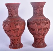 A PAIR OF 19TH CENTURY CHINESE CARVED CINNABAR LACQUER VASES Qing, decorated with figures in