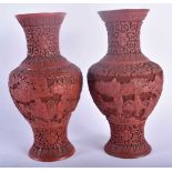 A PAIR OF 19TH CENTURY CHINESE CARVED CINNABAR LACQUER VASES Qing, decorated with figures in