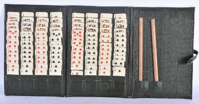 A VINTAGE LEATHER CASED TRAVELLING SOLITAIRE CARD GAME. 24 cm x 15 cm.