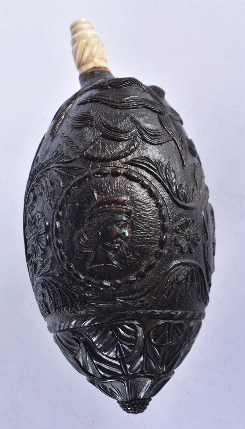 A Bugbear Powder Flask with bone spout, carved with Colonial Scenes. 16cm x 7.5 cm - Image 2 of 4