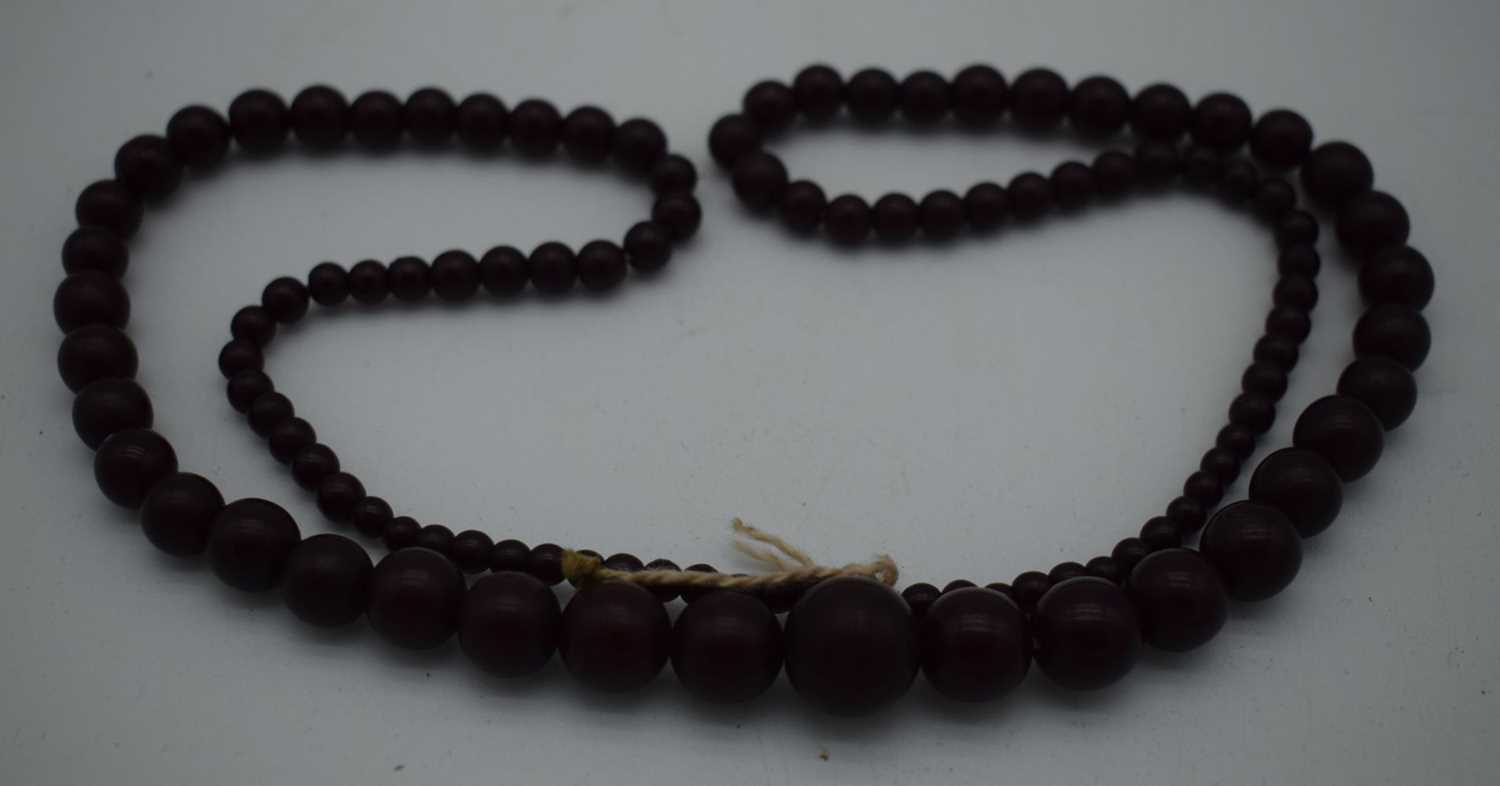 A DEEP RED CHERRY AMBER TYPE NECKLACE. 37 grams. 76 cm long, largest bead 1 cm diameter.