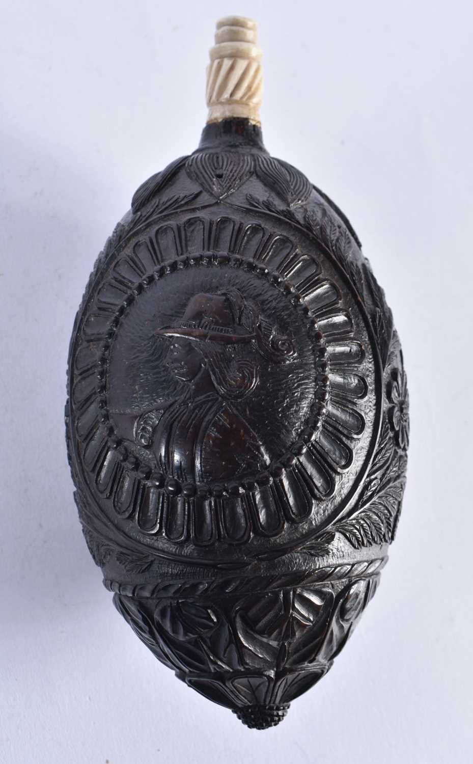 A Bugbear Powder Flask with bone spout, carved with Colonial Scenes. 16cm x 7.5 cm