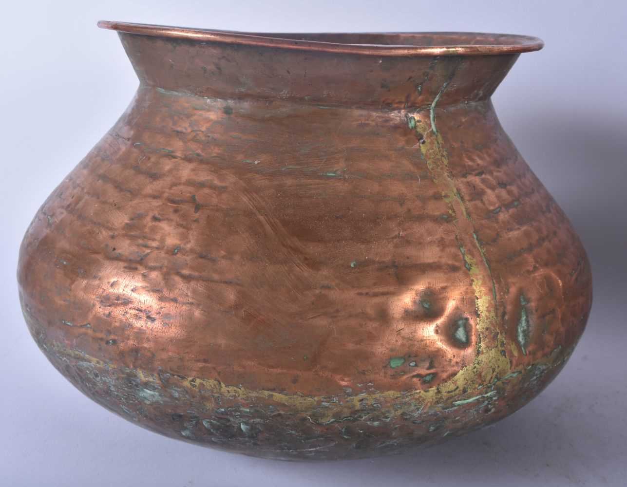 A LARGE EARLY 20TH CENTURY MALAYSIAN HAMMERED COPPER COOKING POT together with other dishes & a - Image 2 of 7