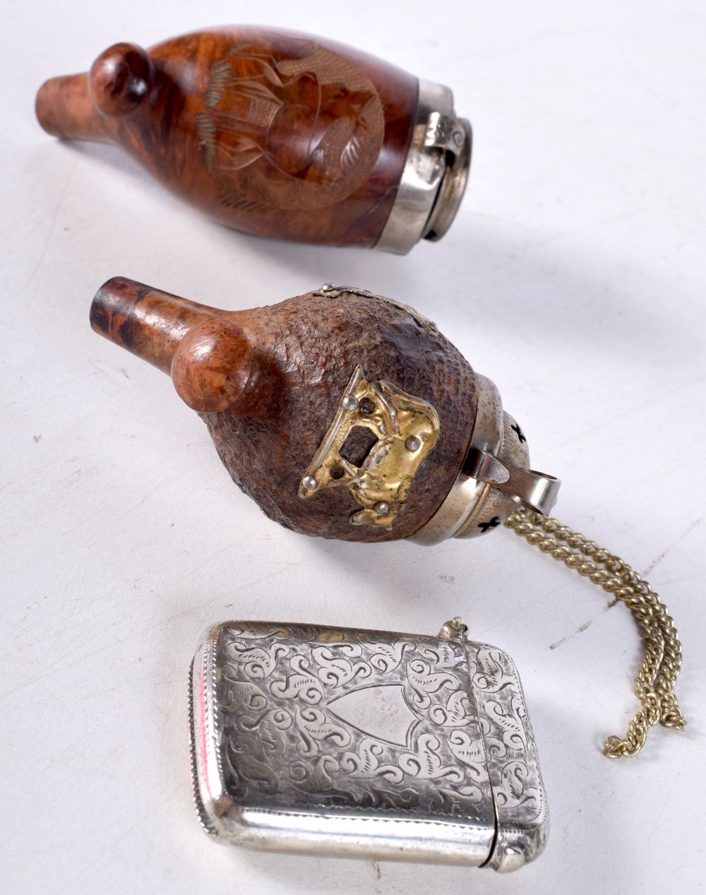 A carved walnut pipe bowl together with another pipe bowl and a Vesta case 8 cm (3)