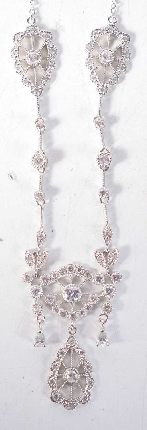 A 14CT GOLD AND DIAMOND NECKLACE. 6.7 grams. Chain 48 cm long, pendant 2.5 cm x 2 cm.