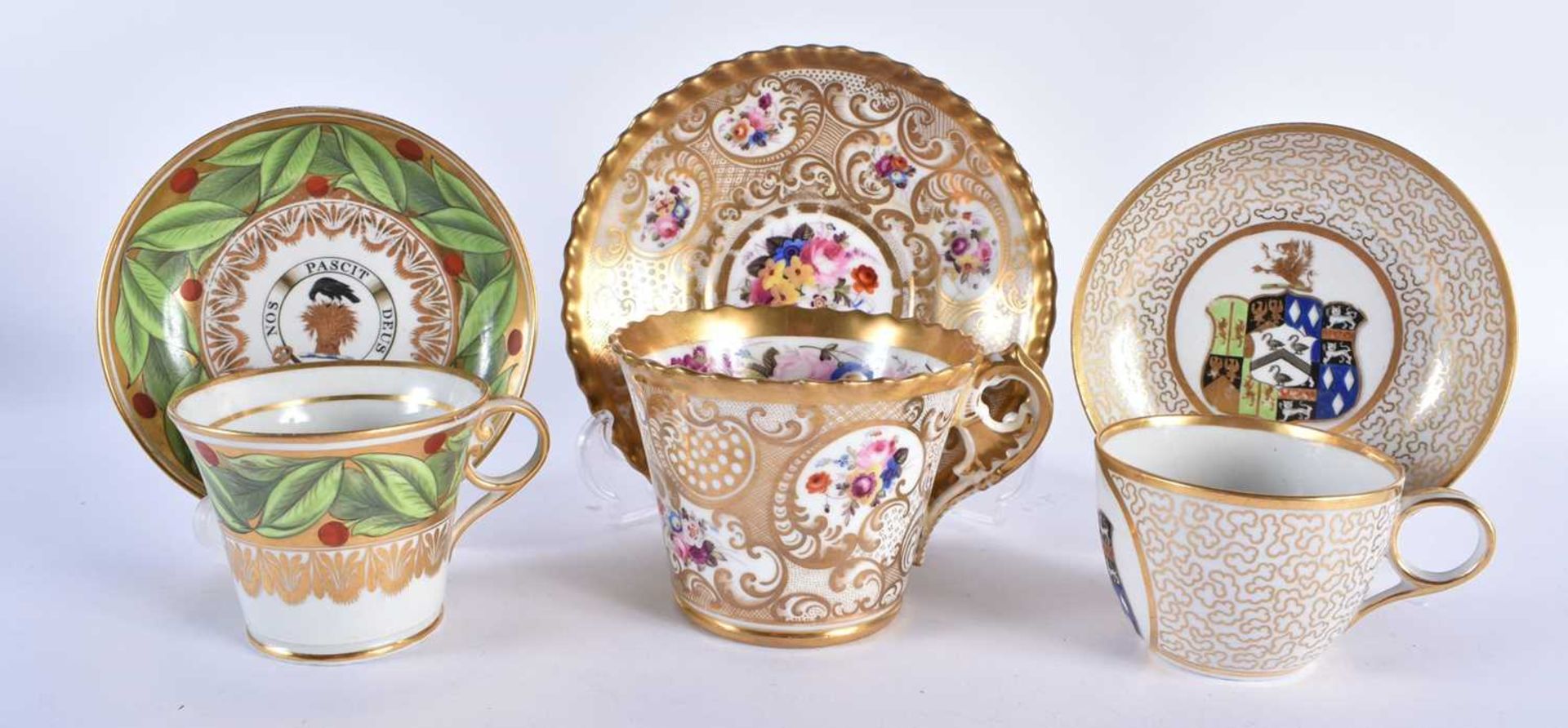 THREE EARLY 19TH CENTURY CHAMBERLAINS WORCESTER PORCELAIN CUPS AND SAUCERS painted with armorials