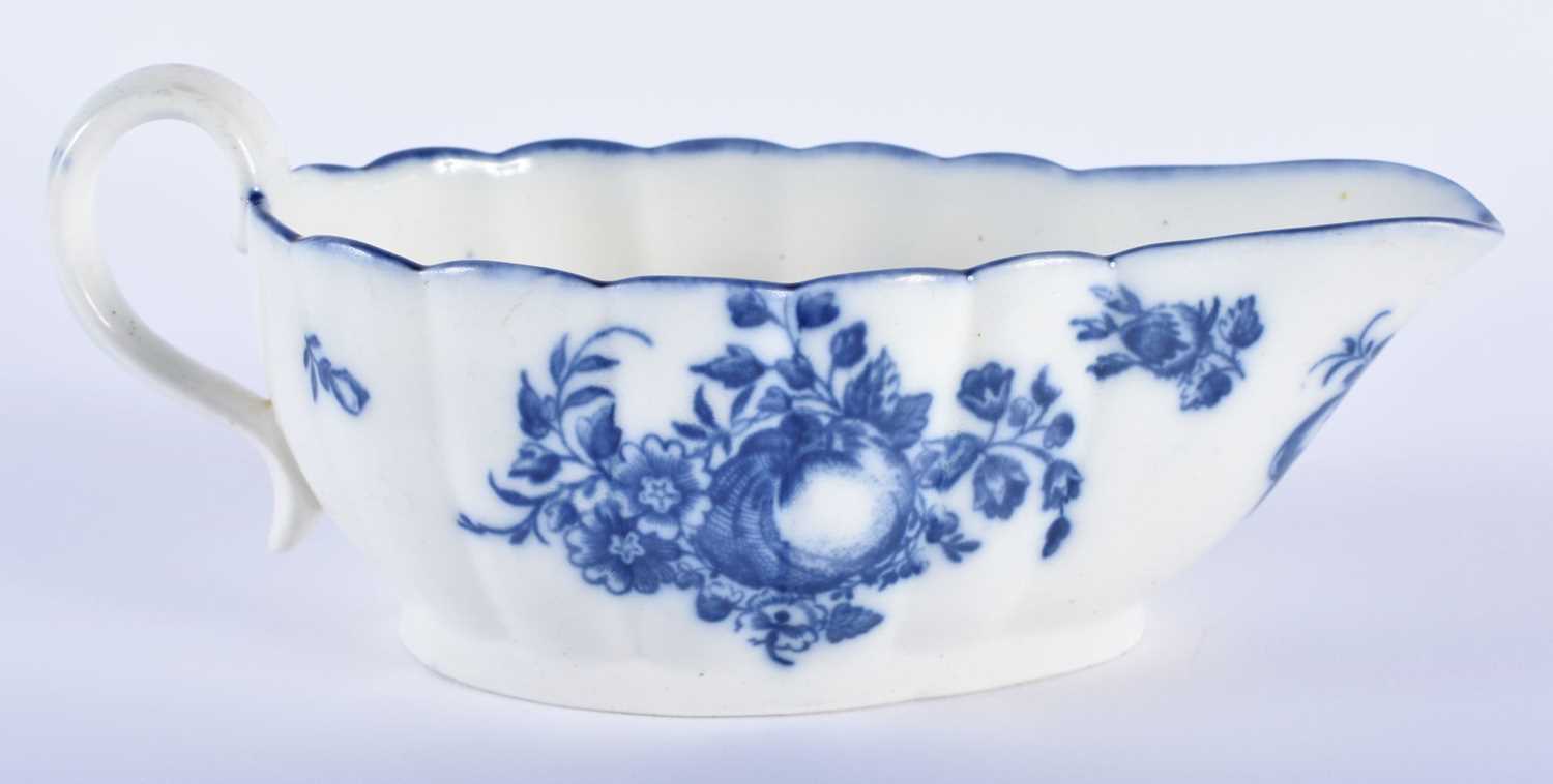 AN 18TH CENTURY CAUGHLEY BLUE AND WHITE PORCELAIN SAUCE BOAT decorated with fruiting vines upon a