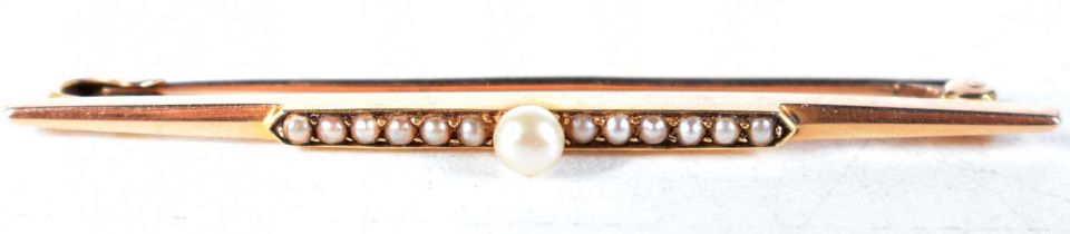 An Edwardian 15 Carat Gold Bar Brooch set with Pearls. Stamped 15CT, 5.5 cm x 0.3 cm, weight 3.5g
